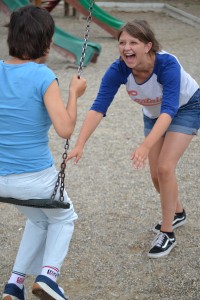 Megan enjoying pushing Monica on the Swing